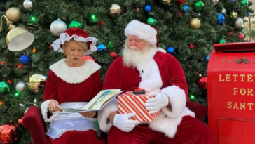 Mike and Debbie Crews dressed as Mr. and Mrs. Claus reading T'was the Night Before Christmas at Devereux's Viera, Florida campus