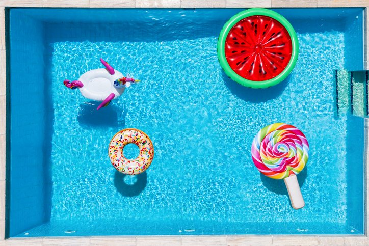 Aerial view of many multi colored inflatables on a swimming pool - Central Florida Lifestyle pool float