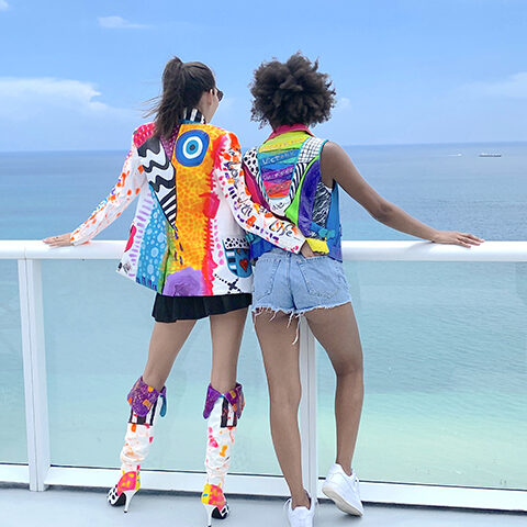 two women showing off their sprayed in style ready to wear art pieces