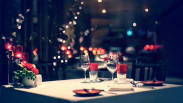 dinner setup, red decoration with candle light in a restaurant. Christmas decoration setting