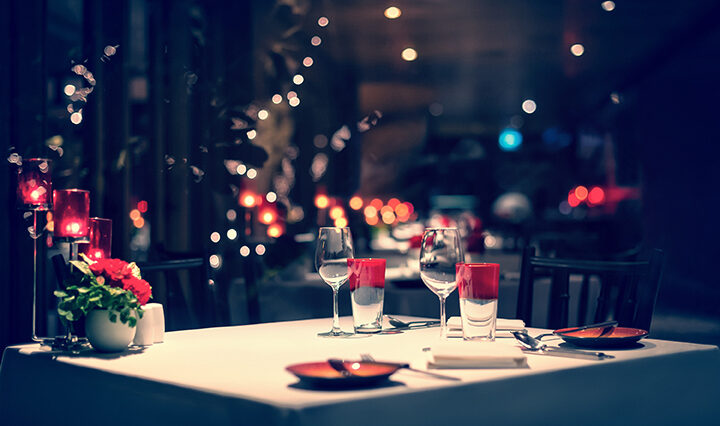 dinner setup, red decoration with candle light in a restaurant. Christmas decoration setting