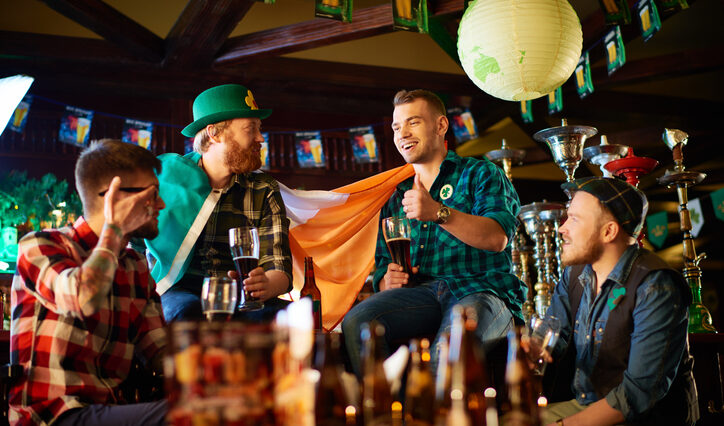 friends enjoying a beer while celebrating St.Patrick's Day