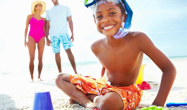 A child and his family at the beach.