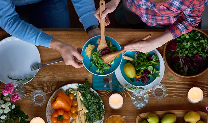 Friends passing around food to create meals.