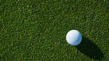 White golf ball on green grass.