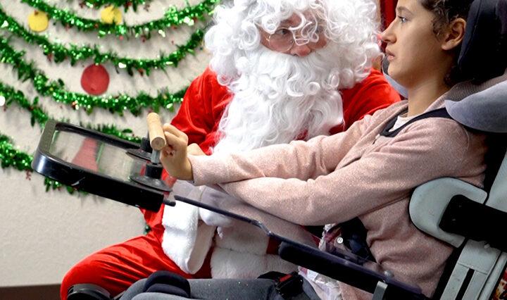 Photo of CECO student interacting with Santa at the school's annual family day event.