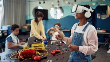 Portrait of young black girl using VR technology in engineering class representing STEM promotion at new East Campus of Orlando Science Charter School.