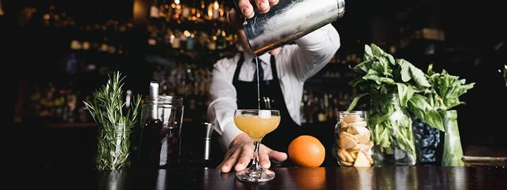 Photo of a bartender at Judson's Live pouring a drink into a glass.