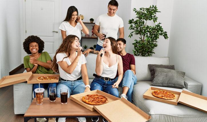 group of friends eating must-have pizza while watching the Super Bowl.