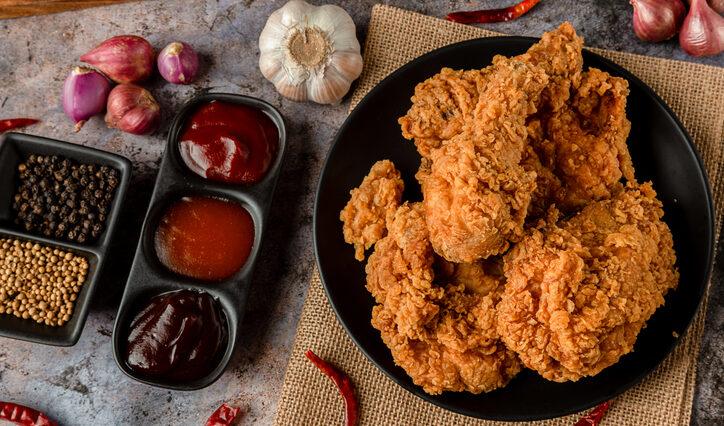 crispy fried chicken plate with sides of sauces for Super Bowl foods.