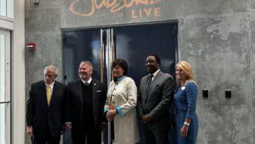 5 officials about to cut a ribbon