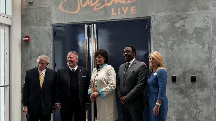 5 officials about to cut a ribbon