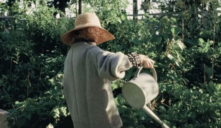 A lady watering her plants