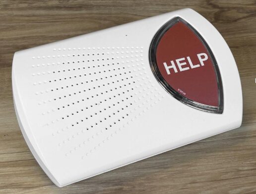 A white medical alert base unit with a prominent red help button on a clean surface