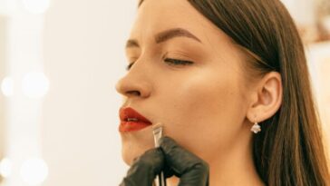 A woman putting on makeup